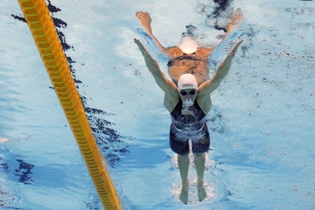 Why do Olympic swimmers wear two swim caps? Picture 3