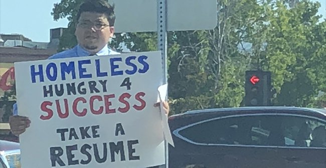 Standing up for a Job Plaque, the Homeless Guy Received