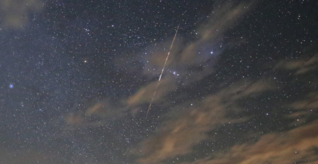 The Meteor Glows and Dissolves Leaving a Golden Light Trail Winding
