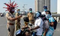 Indian police put on a unique helmet of the invisible SARS-CoV-2 virus to scare people out of their homes