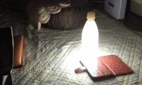 Japanese youths make emergency lights from smartphones and bottles of water for temporary use during a power outage due to a super typhoon