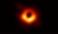 This is a photograph of the first black hole of mankind, located in a galaxy 55 million light-years from Earth