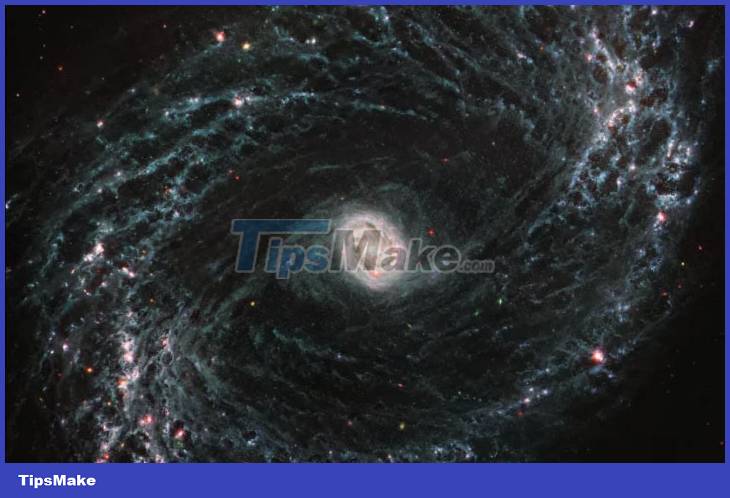 Admire the majestic spectacle of swirls of dust and gas in nearby galaxies Picture 1