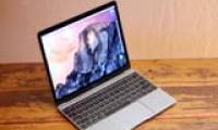 Adjusting the screen brightness on a Macbook laptop.