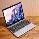 Adjusting the screen brightness on a Macbook laptop.